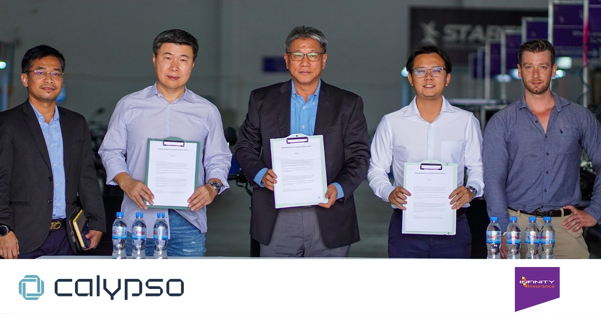 Calypso Motors CEO and management team signing an MOU with Infinity General Insurance and Alpha Insurance Broker, with five representatives holding the agreement documents.