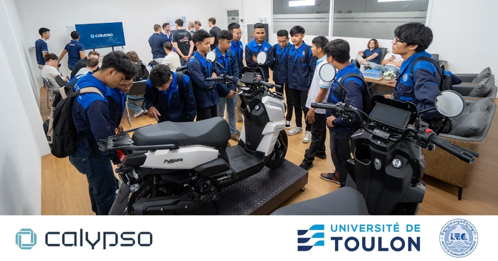 Students from ITC and Université de Toulon examining the Calypso motorcycle display in the meeting room and asking staff questions about the company and its products. Calypso, ITC, and Toulon logos are visible in the image.