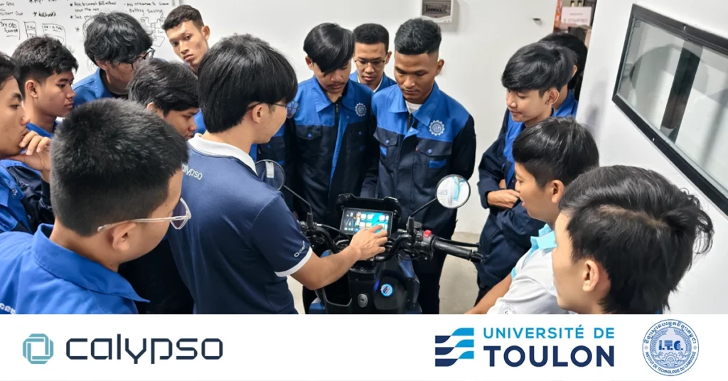Students and professors from ITC and Université de Toulon inside the Calypso R&D area, observing a demonstration of how the Calypso smart system works on the motorcycle. Calypso, ITC, and Toulon logos are visible in the image.